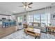 Open living room featuring a ceiling fan, seamlessly connecting to a stylish kitchen with a blue island at 107 Tandil Ct, Summerville, SC 29483