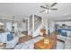 Spacious living room with dining area, staircase, and kitchen access, featuring modern furnishings and wood floors at 107 Tandil Ct, Summerville, SC 29483