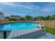 A refreshing in-ground pool with ladder for easy access surrounded by wooden fence at 107 Tandil Ct, Summerville, SC 29483