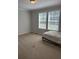 Spacious bedroom with two windows, neutral carpet, and ample natural light at 110 Kay St, Ridgeville, SC 29472