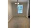 Bright dining room with large window and neutral carpet, awaiting your personal touch at 110 Kay St, Ridgeville, SC 29472