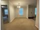 Bright, carpeted dining room with a modern chandelier and natural light from the large window at 110 Kay St, Ridgeville, SC 29472