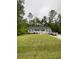 A lovely ranch-style home features a gray exterior, dark shutters, and a spacious front yard at 110 Kay St, Ridgeville, SC 29472