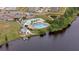 Aerial view of community pool, dock, lake, clubhouse, playground and well-manicured lawn at 110 Ricewood Ln, Moncks Corner, SC 29461