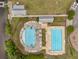 Aerial view of community pool and dock with seating, surrounded by a lawn and lake at 110 Ricewood Ln, Moncks Corner, SC 29461