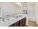 Bright bathroom features double sinks with stylish dark cabinets and shower with tub at 110 Ricewood Ln, Moncks Corner, SC 29461