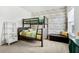 Bright bedroom with a bunk bed, stylish wallpaper, and natural light from a window at 110 Ricewood Ln, Moncks Corner, SC 29461
