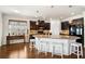 Open kitchen features an island with bar seating, granite counters, and dark wood cabinets at 110 Ricewood Ln, Moncks Corner, SC 29461
