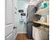 Efficient laundry room with stacked washer/dryer and organized shelving for storage solutions at 110 Ricewood Ln, Moncks Corner, SC 29461