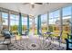 Bright sunroom features large windows, comfortable seating, and a stylish geometric rug at 110 Ricewood Ln, Moncks Corner, SC 29461