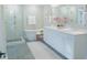Bright bathroom featuring a standalone tub, glass shower, and a double vanity with ample counter space at 1100 Saltwater Cir, Johns Island, SC 29455