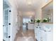 Elegant entryway featuring a hardwood floor, white wainscotting and a view to the kitchen at 1100 Saltwater Cir, Johns Island, SC 29455