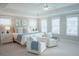 Spacious main bedroom featuring natural light, soft decor, and comfortable seating area at 1100 Saltwater Cir, Johns Island, SC 29455
