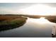 Scenic sunset view of a marsh from a wooden dock at 1100 Saltwater Cir, Johns Island, SC 29455