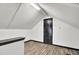 An attic featuring light hardwood floor, and a door at 113 Dove Ln, Summerville, SC 29485