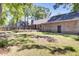 Exterior of brick home highlighting a large backyard with a wooden deck, offering space for outdoor enjoyment at 113 Dove Ln, Summerville, SC 29485