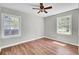 This bedroom has wood floors, a ceiling fan and two windows at 113 Dove Ln, Summerville, SC 29485