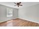 A bedroom featuring a ceiling fan, hardwood floors, and a large window at 113 Dove Ln, Summerville, SC 29485