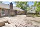 Large wooden deck with a swing and picnic table, attached to a brick home with a prominent chimney at 113 Dove Ln, Summerville, SC 29485