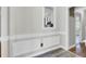 Neutral dining room featuring classic wainscoting, wood-look flooring, and a view into the kitchen at 113 Dove Ln, Summerville, SC 29485