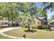 Brick home showcasing a well-maintained lawn, a palm tree, and an inviting driveway at 113 Dove Ln, Summerville, SC 29485