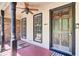 Inviting front porch with decorative columns, a ceiling fan, and a charming wooden front door at 113 Dove Ln, Summerville, SC 29485