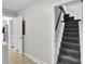 Hallway leading to a carpeted staircase and a doorway that reveals the kitchen at 113 Dove Ln, Summerville, SC 29485