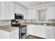 Well-equipped kitchen with stainless steel appliances, ample counter space, and white cabinets at 113 Dove Ln, Summerville, SC 29485