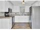 Well-lit kitchen featuring white cabinets, stainless steel appliances, and wood-look flooring at 113 Dove Ln, Summerville, SC 29485