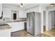 Well-lit kitchen with stainless steel refrigerator, stylish cabinets, and modern countertops at 113 Dove Ln, Summerville, SC 29485