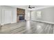 Spacious living room with a brick fireplace, two windows, modern flooring and neutral walls at 113 Dove Ln, Summerville, SC 29485