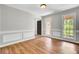 Empty living room featuring fresh paint, hardwood floors, natural light, and classic trim at 113 Dove Ln, Summerville, SC 29485
