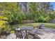 Well-maintained backyard with a stone patio, outdoor seating, a fire pit, and lush greenery at 1166 Turkey Trot Dr, Johns Island, SC 29455