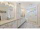 This primary bathroom offers double sinks with a walk-in shower and tile flooring at 1166 Turkey Trot Dr, Johns Island, SC 29455