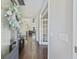 Inviting foyer with hardwood floors leads to an open-concept living space, and a glass panel door at 1166 Turkey Trot Dr, Johns Island, SC 29455