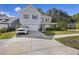 Traditional home with a two-car garage, mature landscaping, and a classic, covered front porch at 1166 Turkey Trot Dr, Johns Island, SC 29455