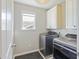 The laundry room has sleek, modern washer and dryer sets with great natural light at 1166 Turkey Trot Dr, Johns Island, SC 29455