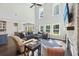Open concept living area with a high ceiling, fireplace, and a large sectional couch at 1166 Turkey Trot Dr, Johns Island, SC 29455