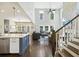Open-concept living room features a fireplace, lots of natural light, and an elegant staircase at 1166 Turkey Trot Dr, Johns Island, SC 29455
