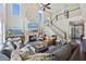 Living room with stone fireplace, large windows, elegant staircase, and hardwood flooring throughout at 1166 Turkey Trot Dr, Johns Island, SC 29455