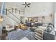 Open-concept living room featuring soaring ceilings, a cozy fireplace, and seamless flow to the dining area at 1166 Turkey Trot Dr, Johns Island, SC 29455