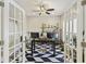 Bright office with a stylish rug, ceiling fan, and double glass doors for enhanced natural light at 1166 Turkey Trot Dr, Johns Island, SC 29455