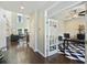 Office entrance featuring a glass panel door, high ceilings, and hardwood floors throughout the home at 1166 Turkey Trot Dr, Johns Island, SC 29455