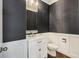 Stylish powder room with dark textured wallpaper, white wainscoting, and a marble countertop sink at 1166 Turkey Trot Dr, Johns Island, SC 29455