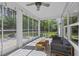 Relaxing screened porch featuring a ceiling fan, outdoor seating, and a view of the green backyard at 1166 Turkey Trot Dr, Johns Island, SC 29455
