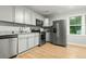 Modern kitchen featuring gray cabinets, stainless steel appliances, and bright natural light at 120 Lisa Dr, Summerville, SC 29485