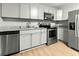 Modern kitchen features stainless steel appliances, gray cabinets, and sleek granite countertops at 120 Lisa Dr, Summerville, SC 29485