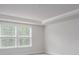 Well-lit bedroom featuring large windows, and decorative ceiling trim at 121 Royal Cainhoy Way, Huger, SC 29450