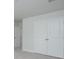 White closet doors with round knobs and light gray walls in a room with neutral carpeting at 121 Royal Cainhoy Way, Huger, SC 29450
