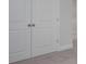 A close-up of double closet doors with round knobs and light gray walls and trim at 121 Royal Cainhoy Way, Huger, SC 29450